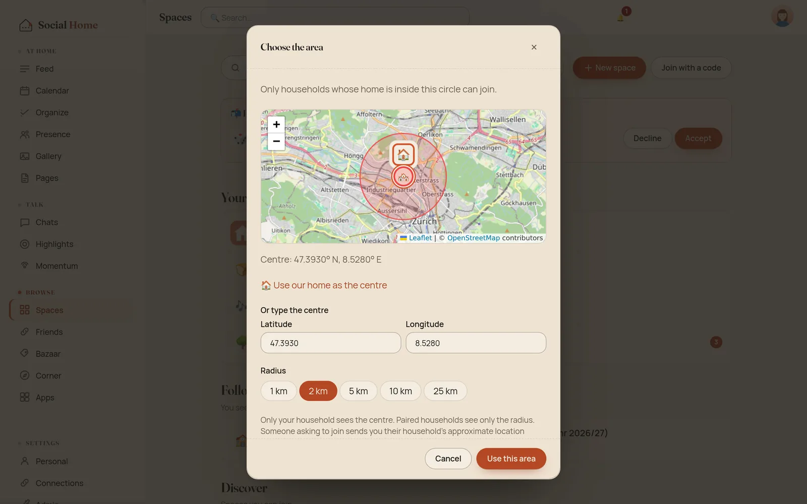 The Choose the area dialog with a map of Zürich showing a 2 km circle, the centre's coordinates, a Use our home as the centre link, latitude and longitude fields, radius chips 1, 2, 5, 10 and 25 km with 2 km picked, and a note that only your household sees the centre and paired households see only the radius